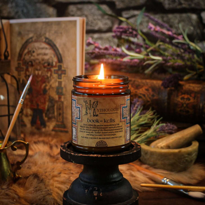Book of Kells Candle with ancient book and lavender, evoking monastic tranquility through scents of ink, leather, and sweet musk.