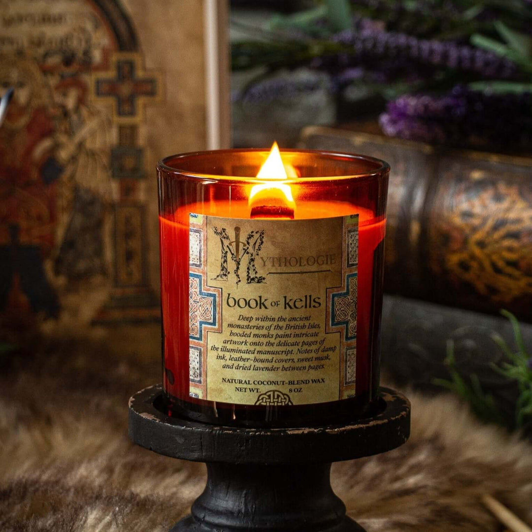 Book of Kells Candle lit on a wooden stand surrounded by ancient monastery-themed decor
