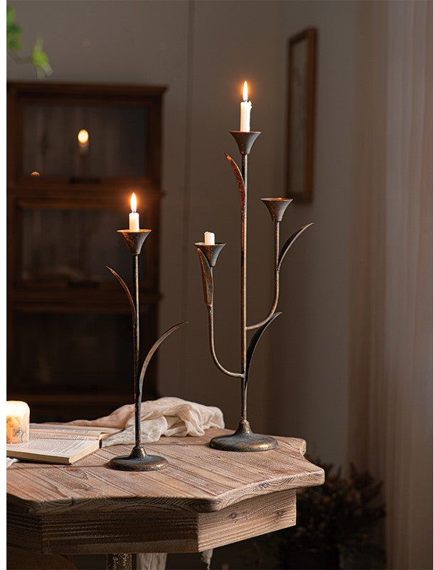 Botanical Iron Taper Candle Holders displayed together on a wood tabletop