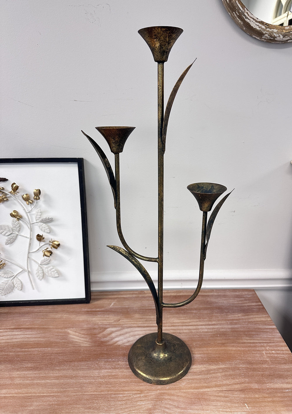 Large Botanical Iron Taper Candle Holder styled with three lit tapers
