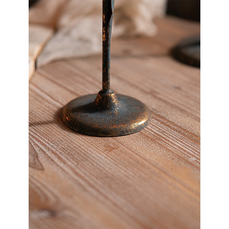 Close view of the rounded base and aged iron finish