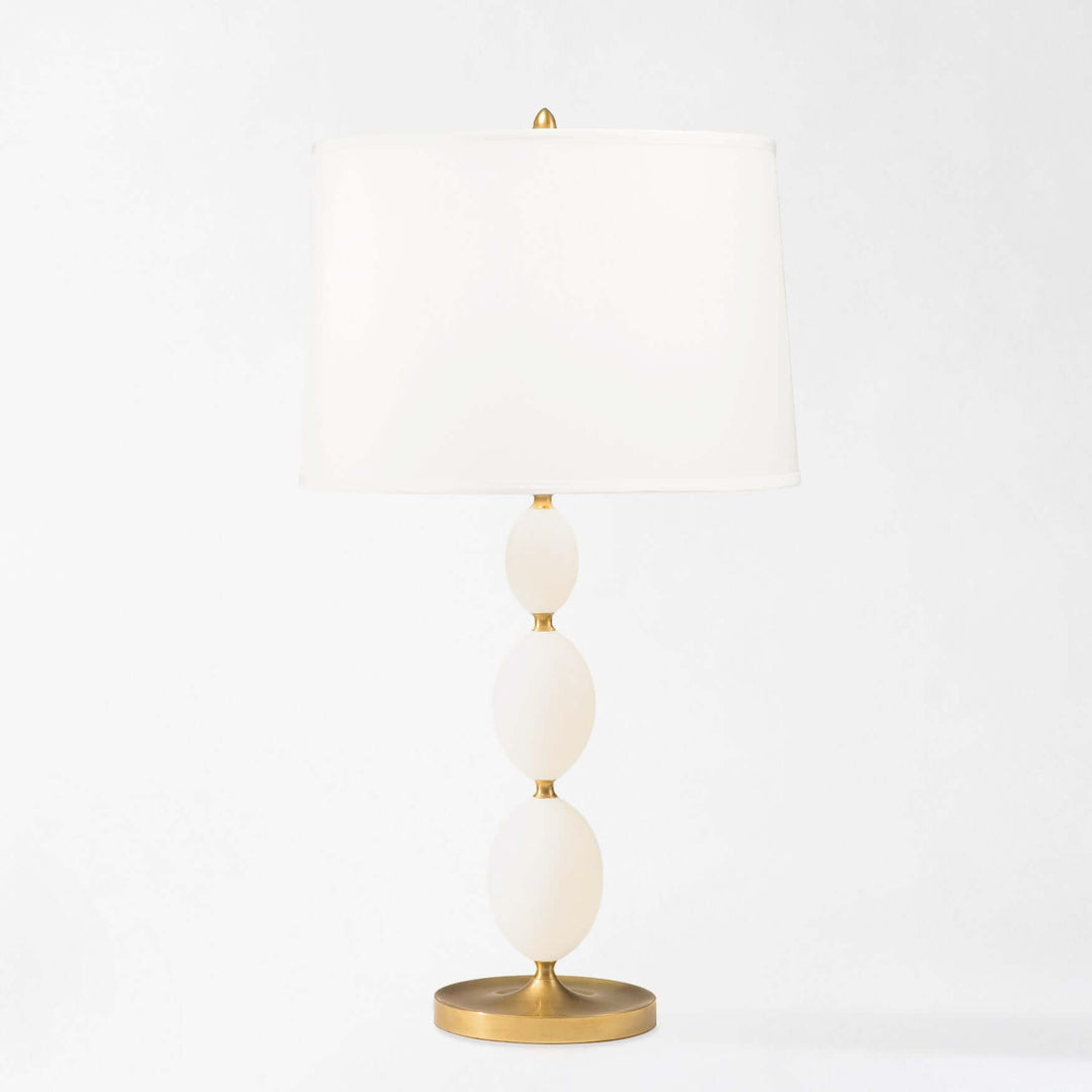 Decorative lamp with white spherical shades and gold accents on a light gray background