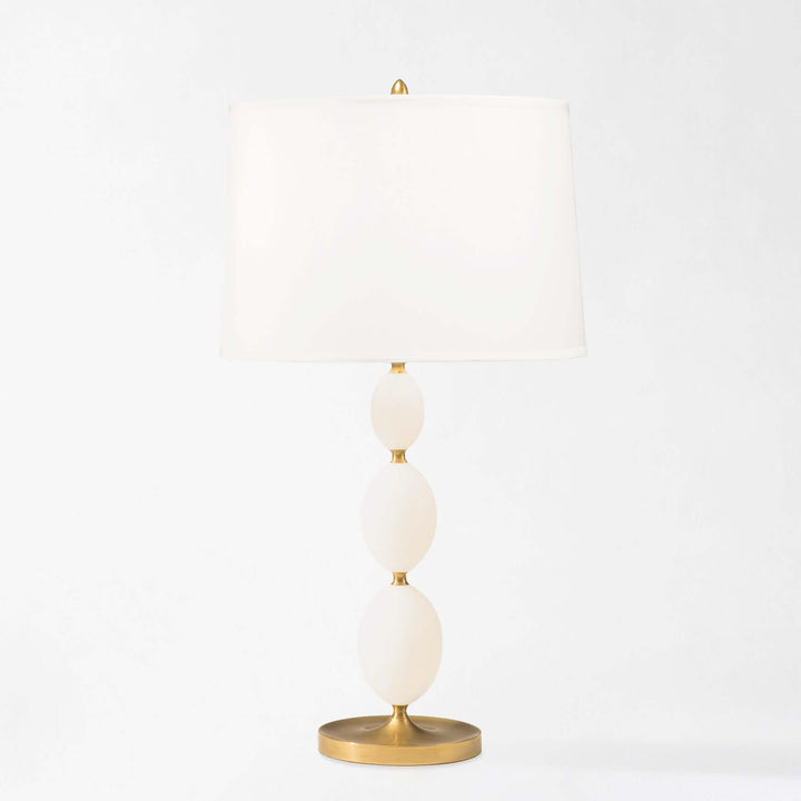 Decorative lamp with white spherical shades and gold accents on a light gray background