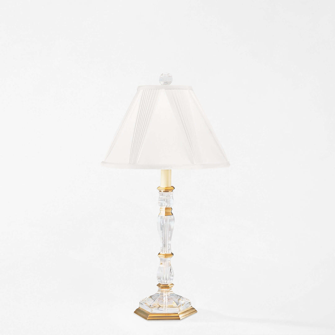 Decorative table lamp with a white shade on a white background