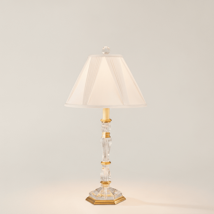 Decorative table lamp with a white shade on a neutral background