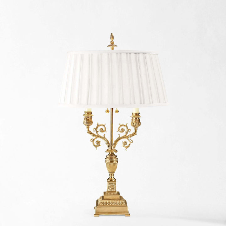 Decorative gold lamp with a white lampshade on a white background