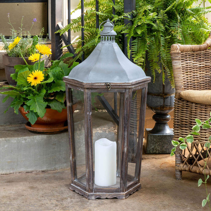 Briarwick Carriage Lantern, large: lantern styled with a white candle on a sheltered porch