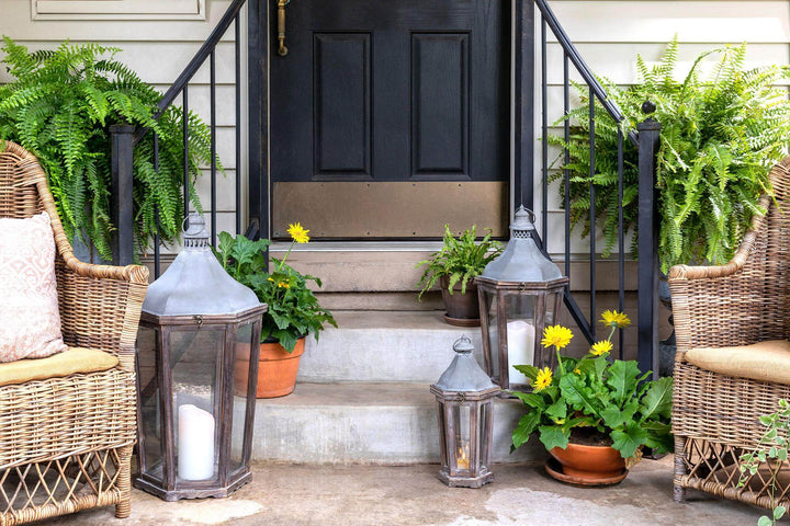 Briarwick Carriage Lantern, large: lanterns arranged on porch steps beside wicker chairs