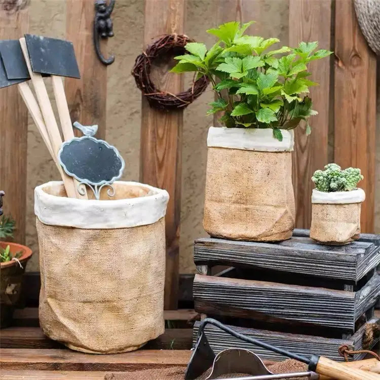 Burlap-Textured Cement Bag Planters in two sizes with leafy plants