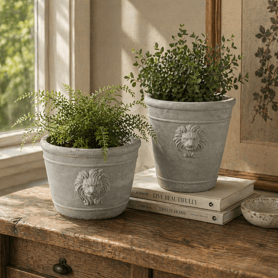 Tall Cast Cement Lion Head Planter filled with pansies