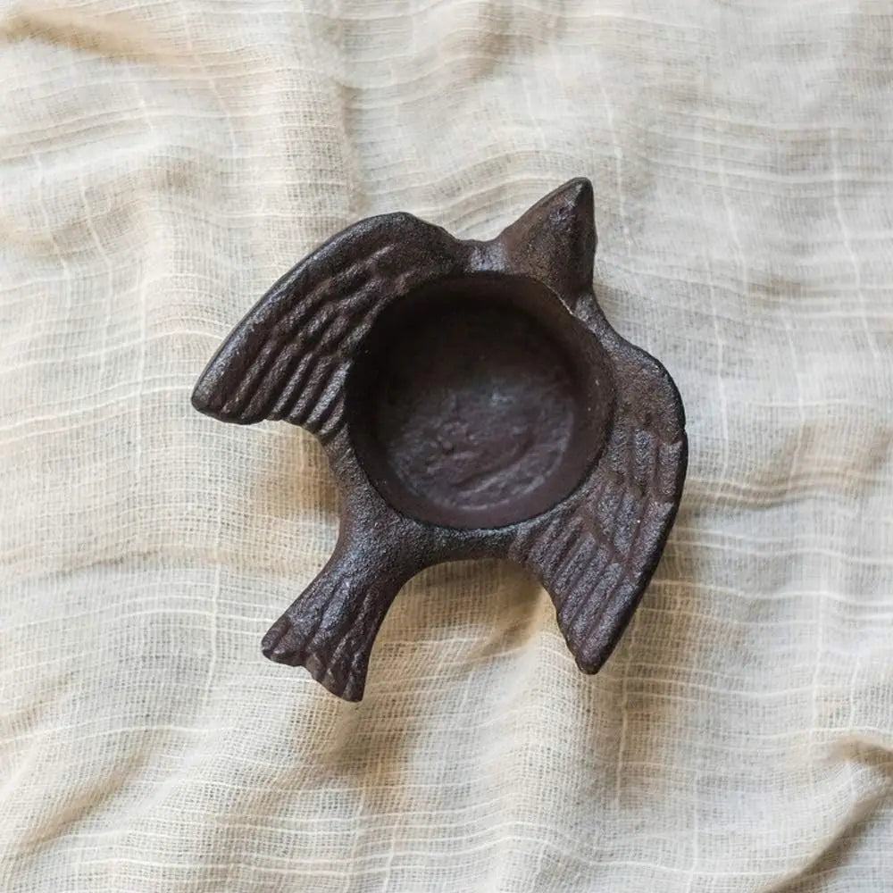 Top view of cast iron bird tea light holder showing textured wings