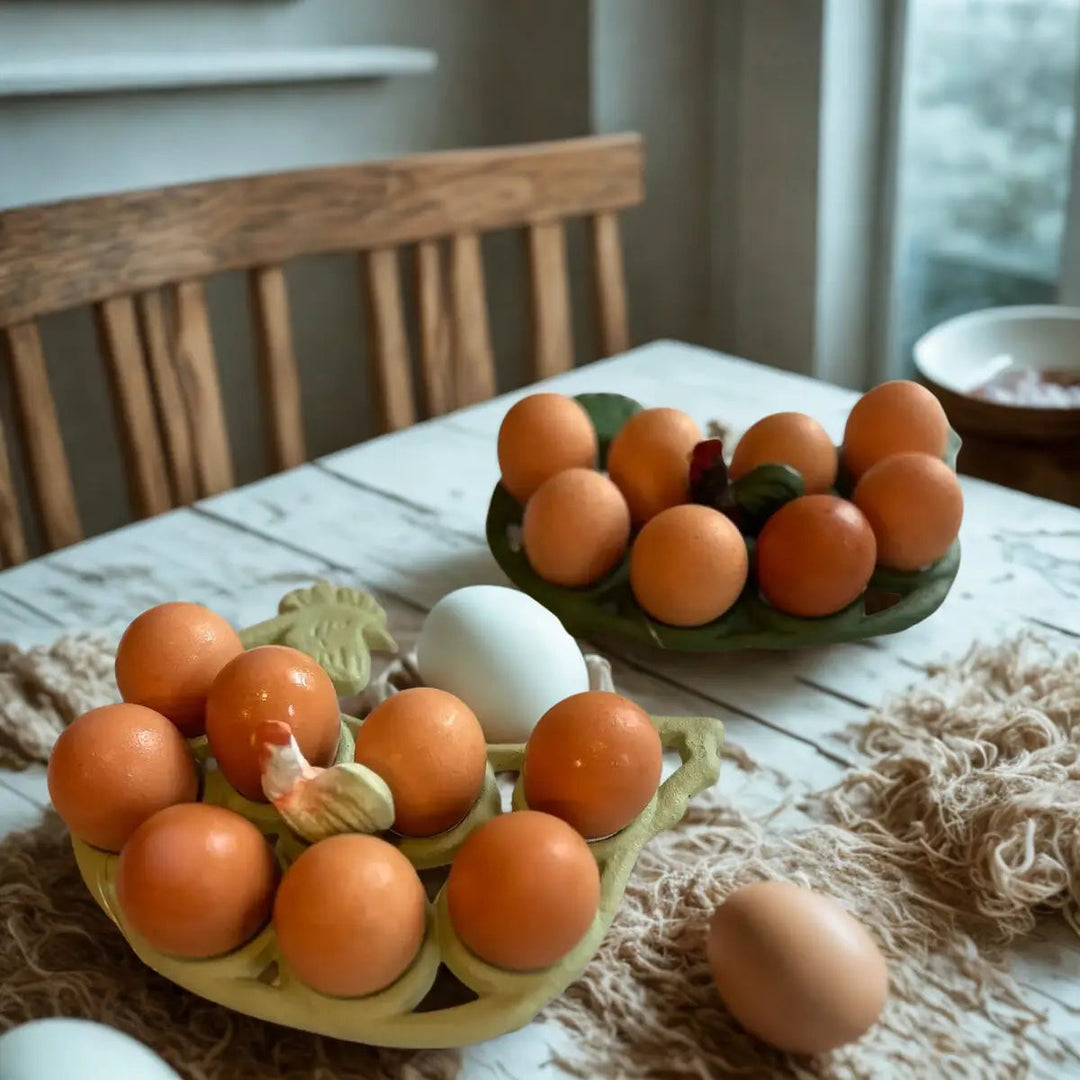 Light and dark green rooster egg racks filled with eggs on a table