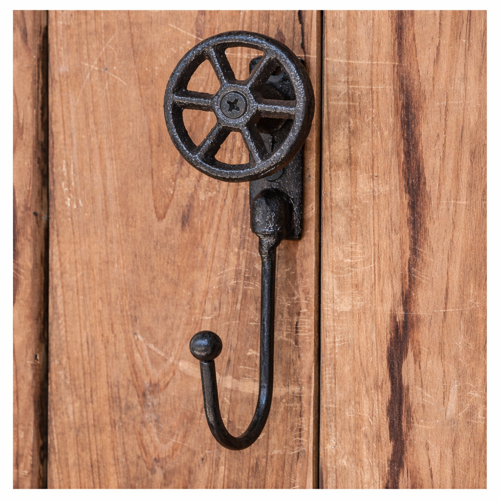 Front view of Cast Iron Valve Wheel Wall Hook mounted on wood