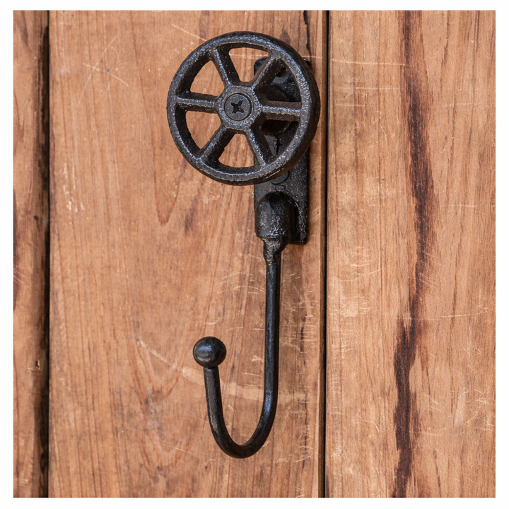 Front view of Cast Iron Valve Wheel Wall Hook mounted on wood