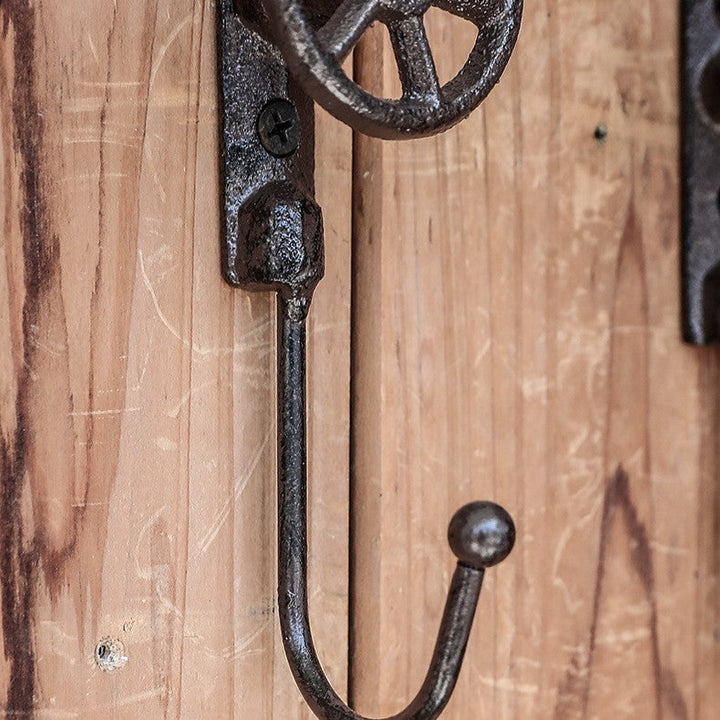 Close view of textured curved hook and valve wheel mounting plate