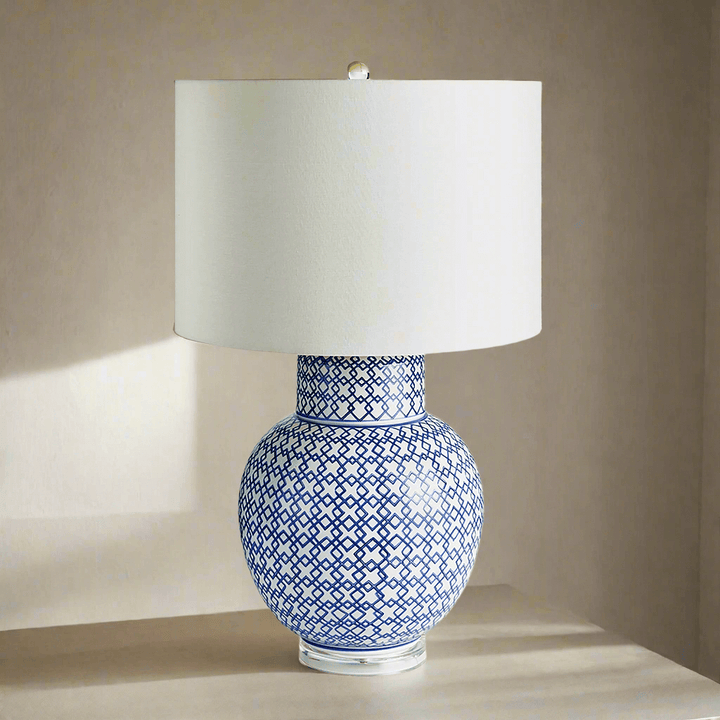 Chinoiserie blue and white ginger jar lamp with a white shade, showcasing elegant porcelain design and classic silhouette.