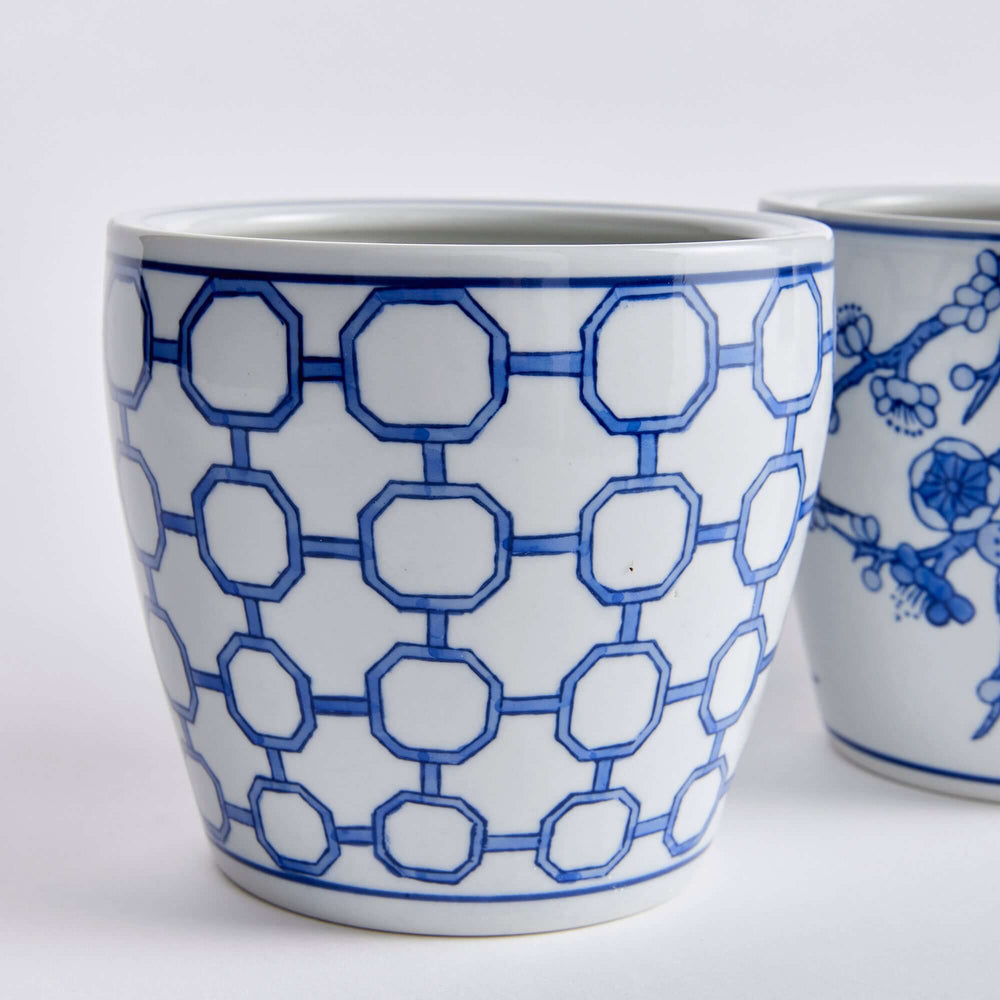 Set of 4 blue and white chinoiserie pots with floral and geometric patterns, evoking antique East Asian ceramic artistry.