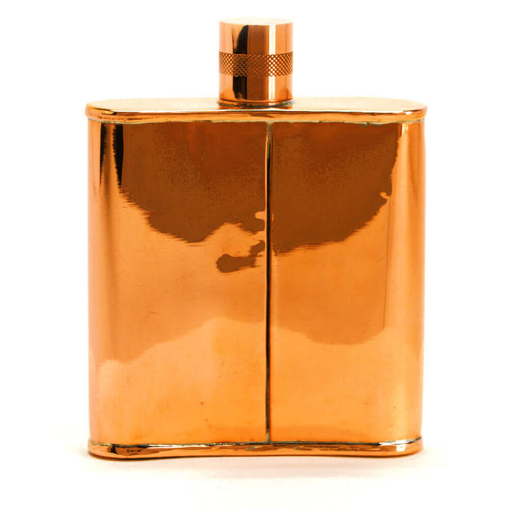 Copper flask with a metallic cap on a white background