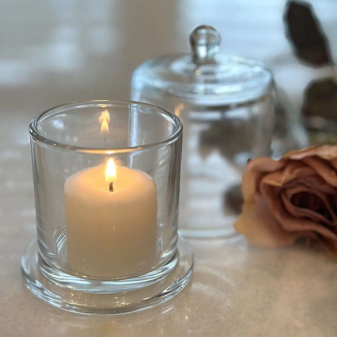 Small footed glass candle holder with dome behind
