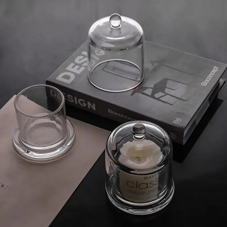 Two sizes of clear glass cloche candle holders in a modern vignette