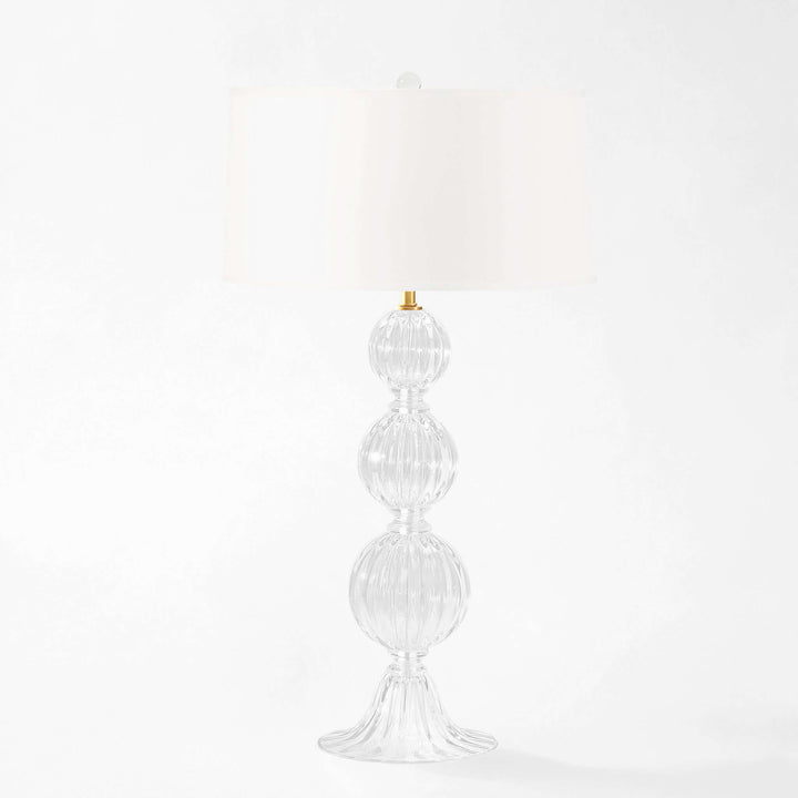 Decorative Murano glass table lamp with a white shade on a white background