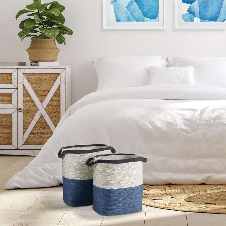 Coastal blue and natural woven storage baskets with handles on a bedroom floor, enhancing seaside-inspired decor.