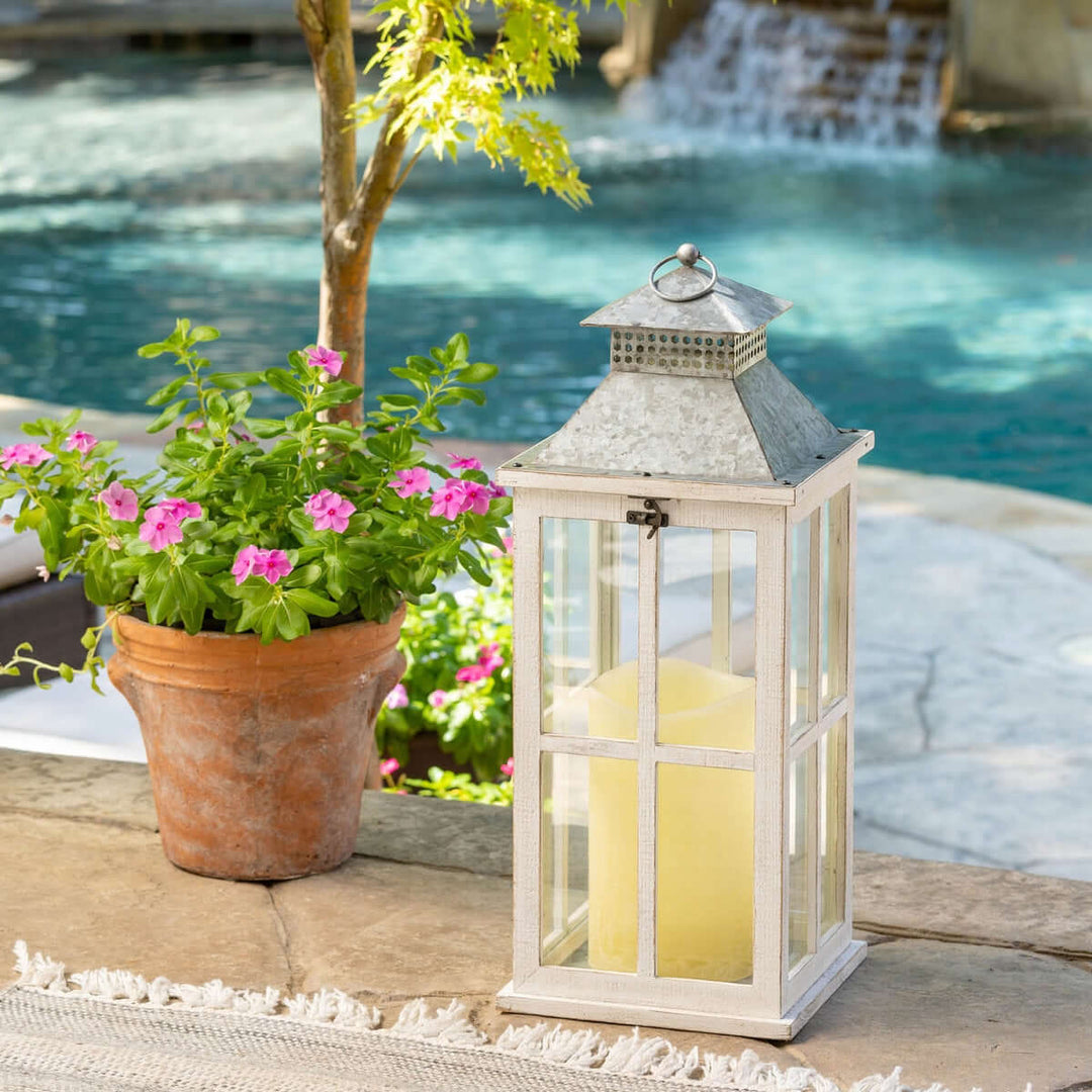 Coastal Whitewash Wood and Glass Lantern with Galvanized Metal Top by a poolside, evoking seaside charm and old-world elegance.