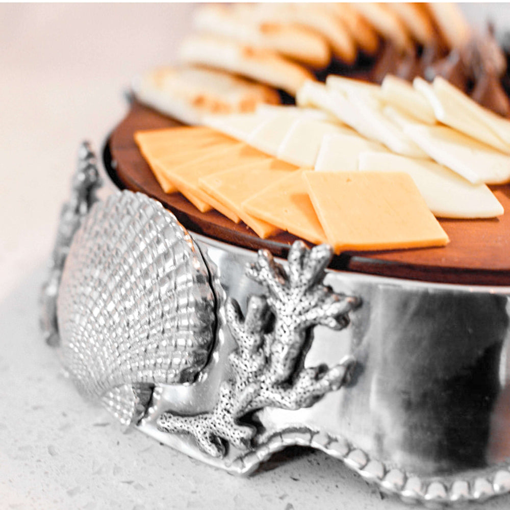 Coastal Shell and Coral Cheese Board Pedestal with decorative shell and coral design, topped with assorted cheese slices.
