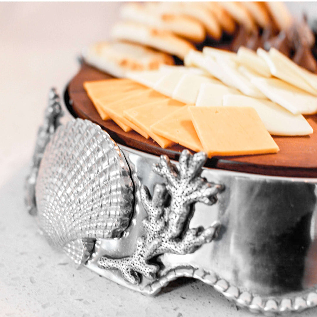 Coastal Shell and Coral Cheese Board Pedestal with decorative shell and coral design, topped with assorted cheese slices.