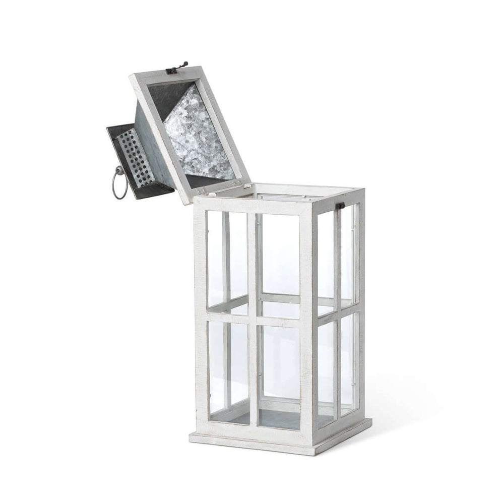Coastal whitewash wood and glass lantern with galvanized metal top, evoking seaside charm and old-world elegance.