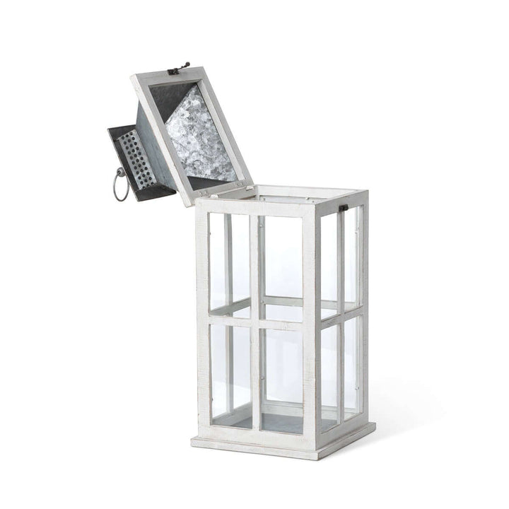 Coastal whitewash wood and glass lantern with galvanized metal top, evoking seaside charm and old-world elegance.