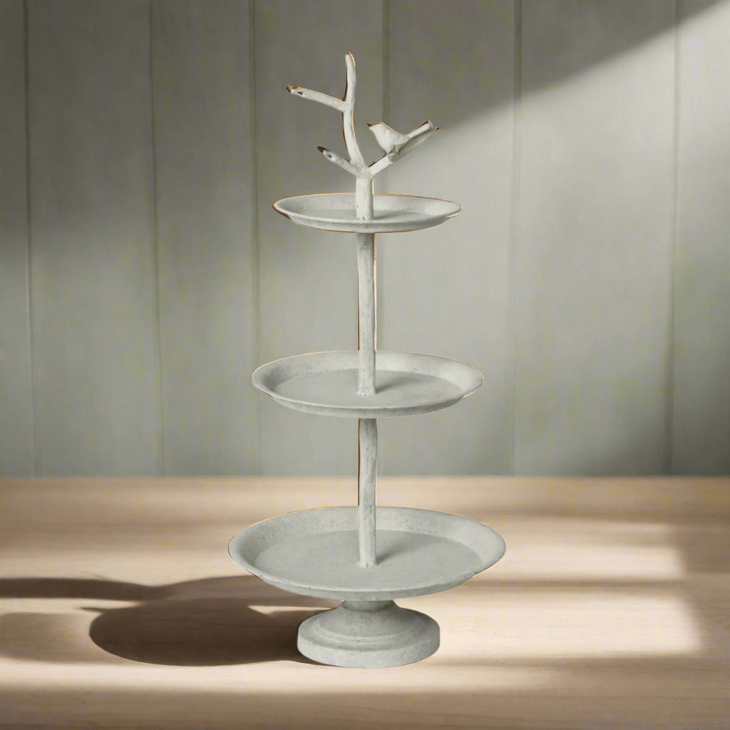 Cottagecore tiered display stand with bird detail, three trays, weathered iron finish, perfect for rustic kitchen or garden decor.