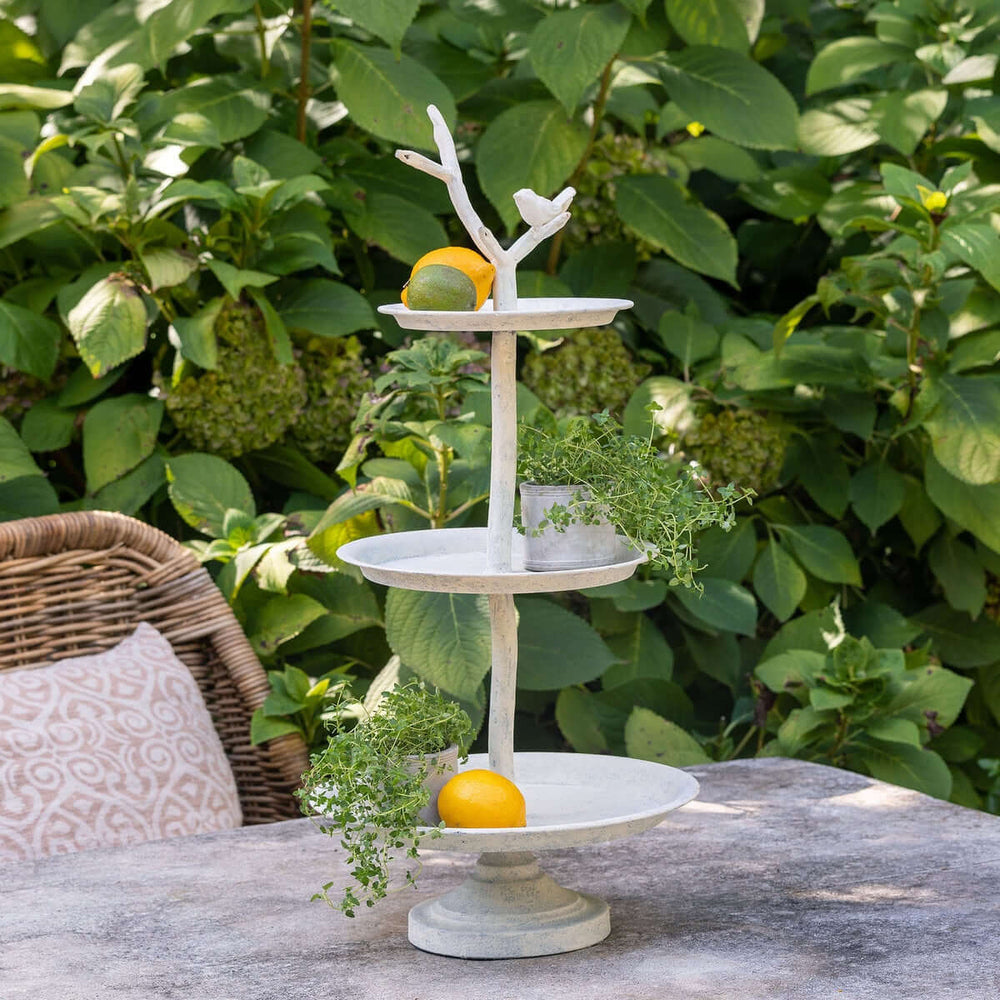 Cottagecore tiered display stand with bird detail, featuring three trays and rustic iron finish, ideal for home or garden decor.