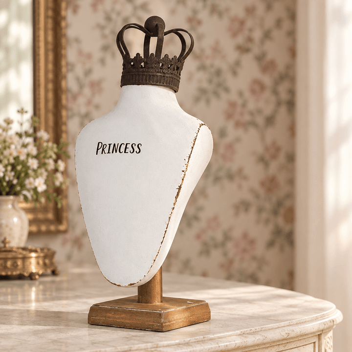 Crowned Resin Jewelry Bust on a pale stone console with softly blurred floral wallpaper