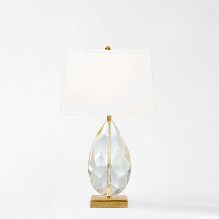Crystal teardrop table lamp on a gold stand against a white background