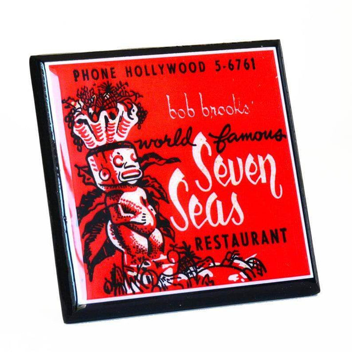 Coaster with vintage design of 'Seven Seas' restaurant featuring a tiki figure on a red background.