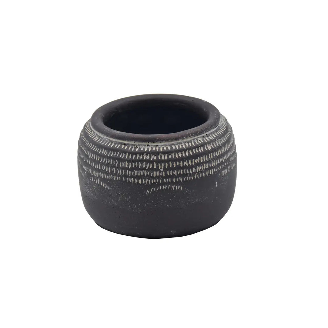 Dark rounded planter isolated to show its pale incised relief pattern