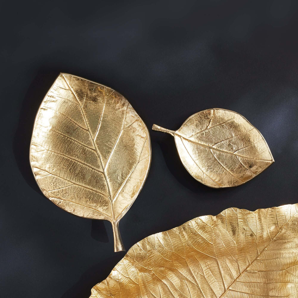 Set of 2 decorative gold leaf-shaped trays, showcasing intricate details and a luxurious finish.
