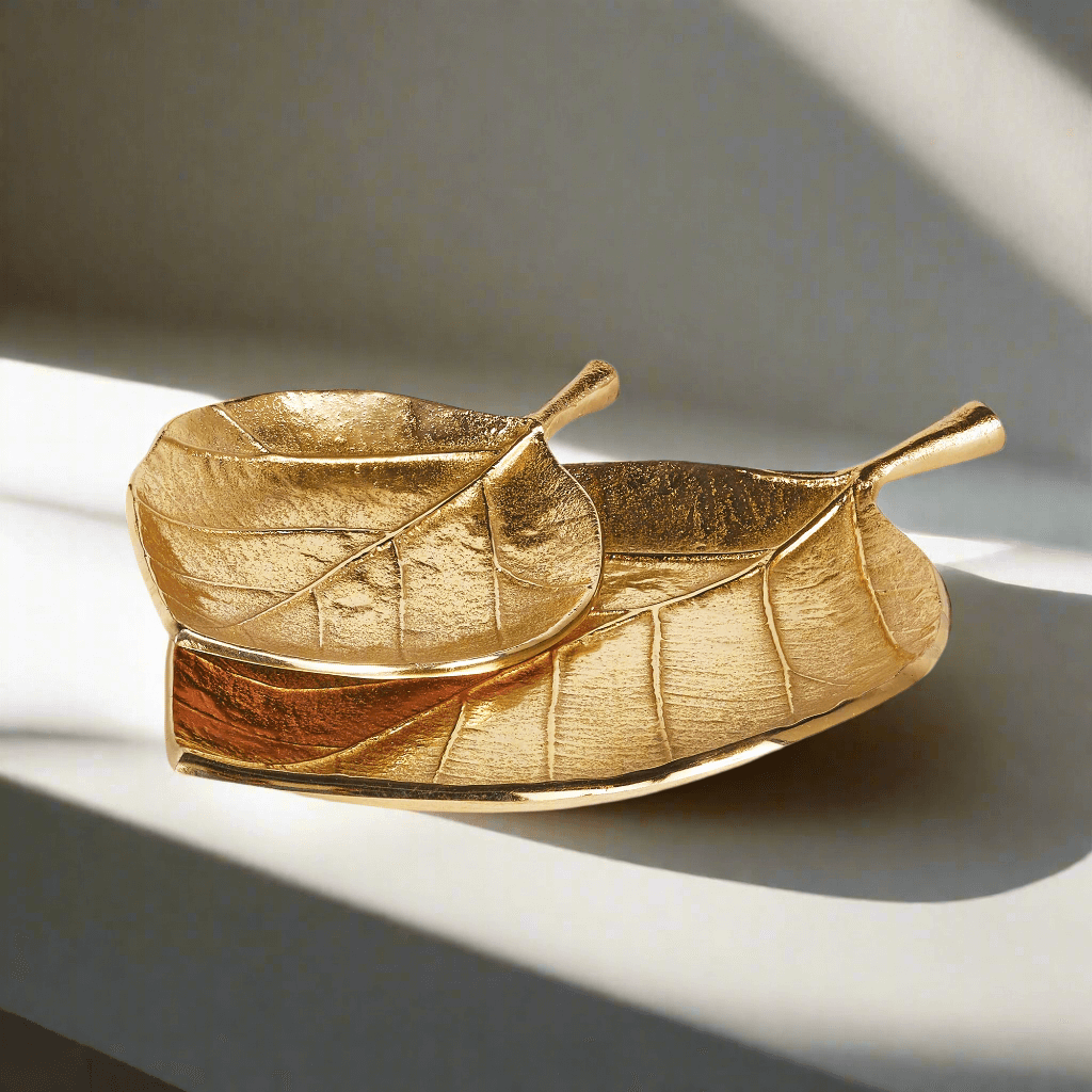Decorative gold leaf-shaped trays set of 2 showcasing intricate detail and a lustrous finish.