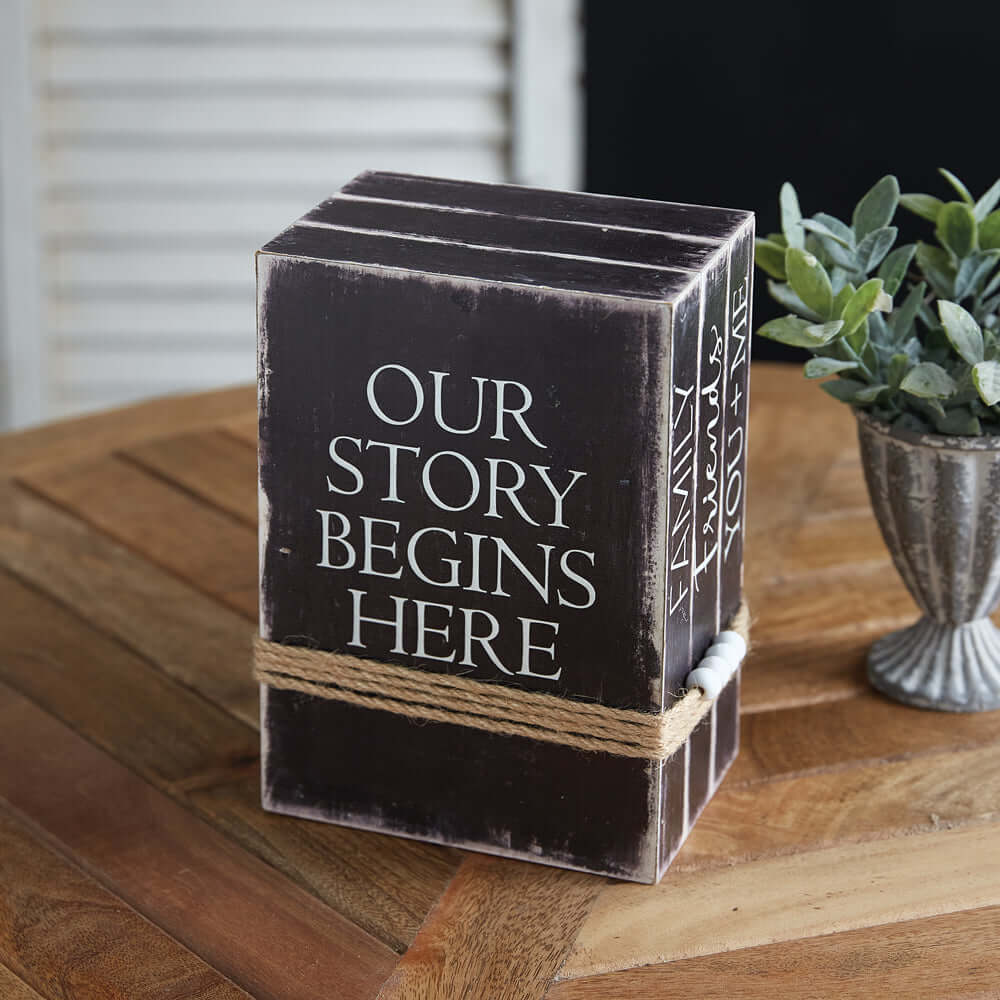 Decorative Vintage Faux Book Stack on a wooden table next to a plant for home decor