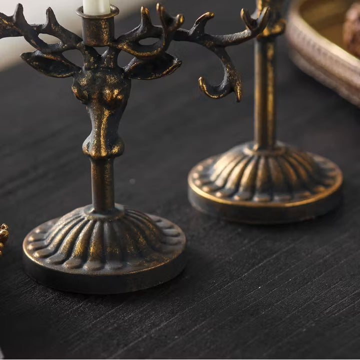 Close view of the sculpted deer head on a taper candle holder