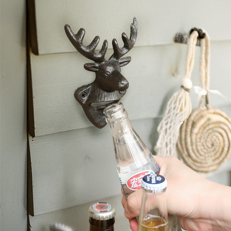 Deer Head Cast Iron Wall Bottle Opener in use on a paneled wall