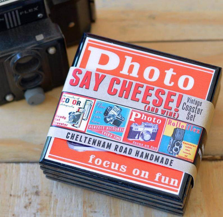 Set of vintage-style photo coasters with a camera in the background