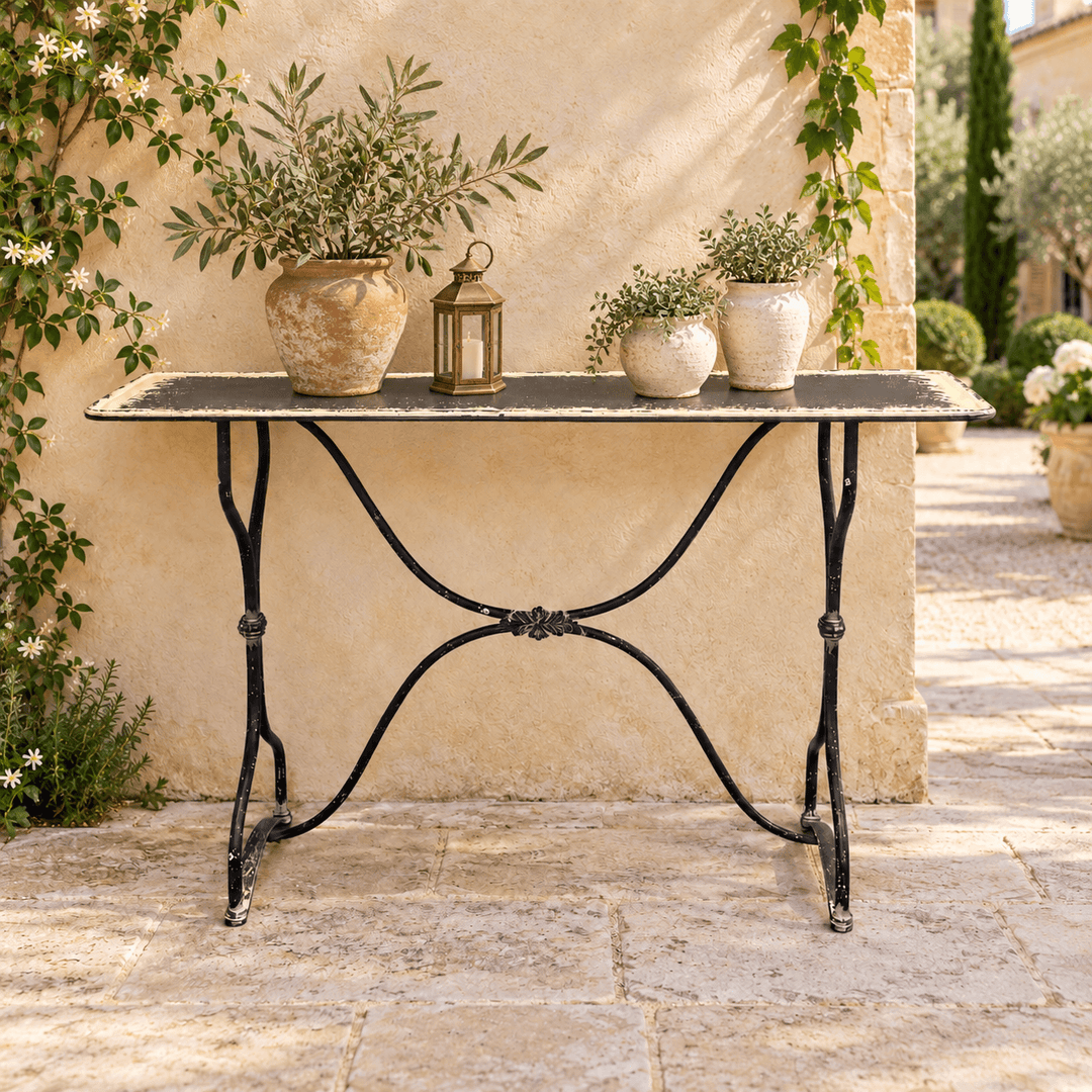 Distressed Black and Cream Metal Console Table styled on a garden terrace