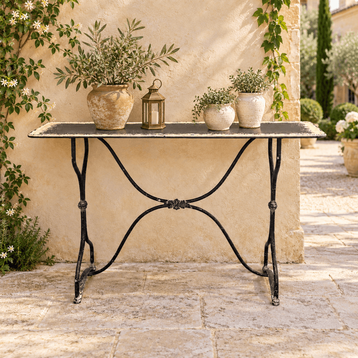 Distressed Black and Cream Metal Console Table styled on a garden terrace