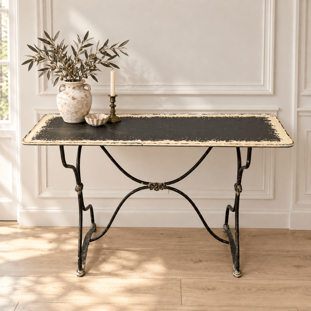 Distressed Black and Cream Metal Console Table in a paneled entryway