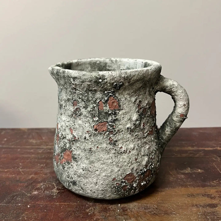Weathered pitcher planter styled on a farmhouse shelf