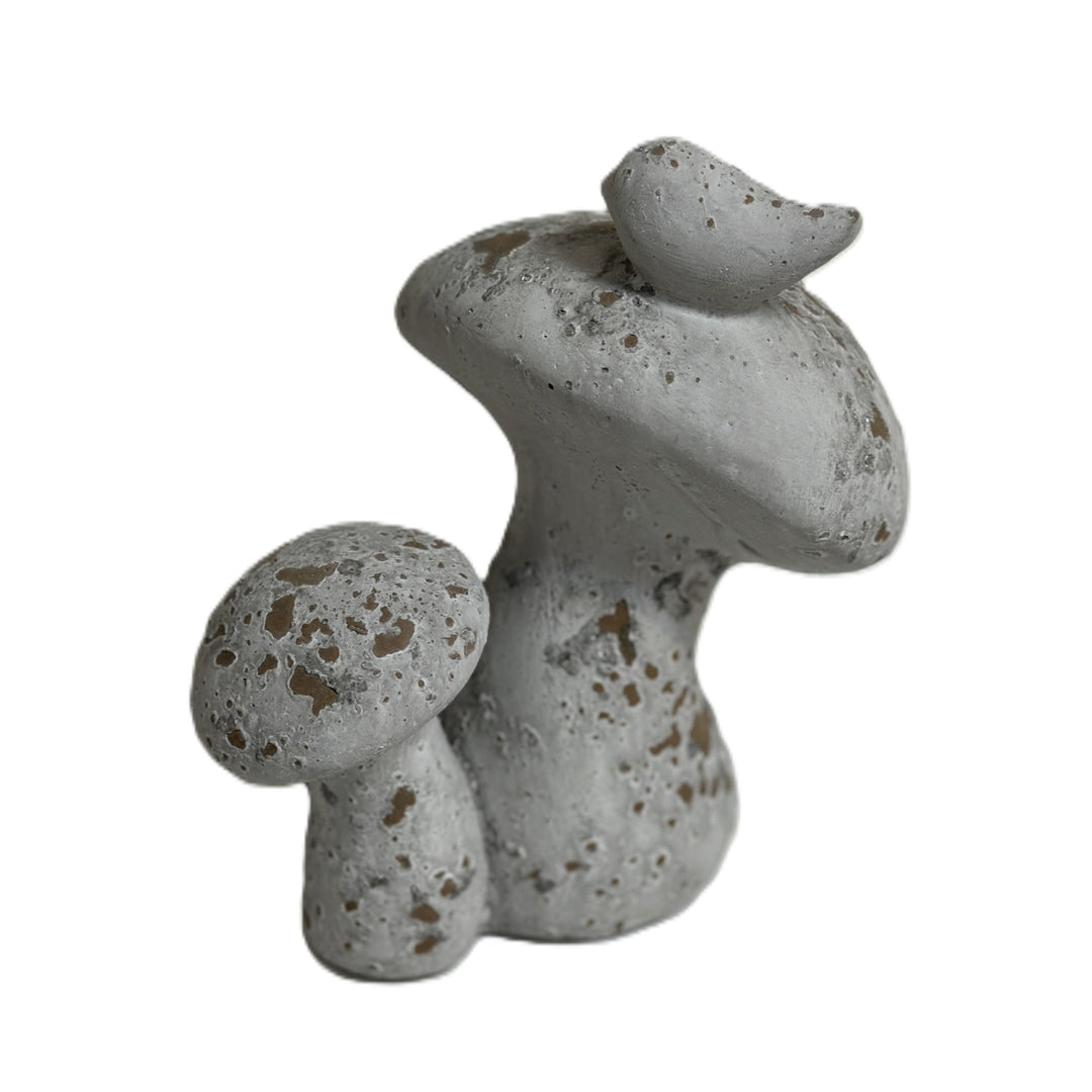 Close view of bird and mushroom cap texture on distressed cement sculpture