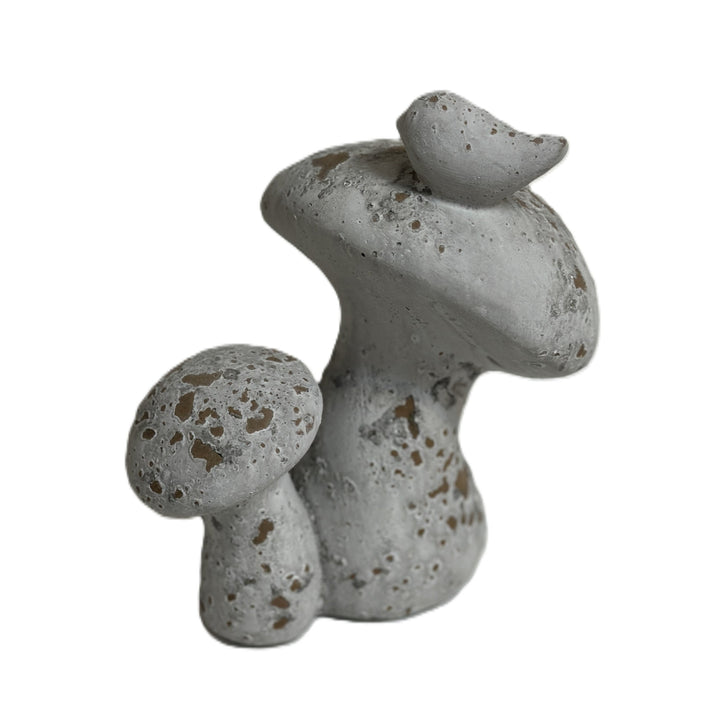 Close view of bird and mushroom cap texture on distressed cement sculpture