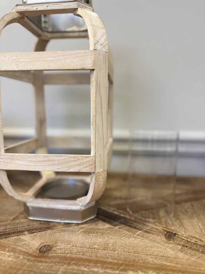 Side view of the white wooden lantern showing its curved ribs and metal base